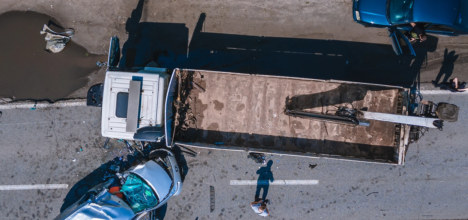 A semi truck and car accident between two vehicles from and aerial view